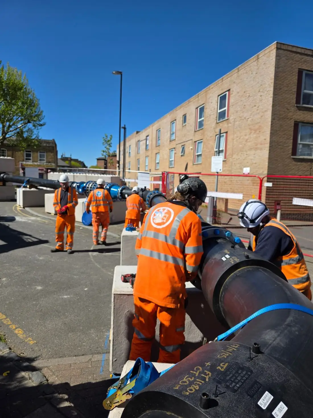 Engineers installing a large-diameter water main on a London scheme