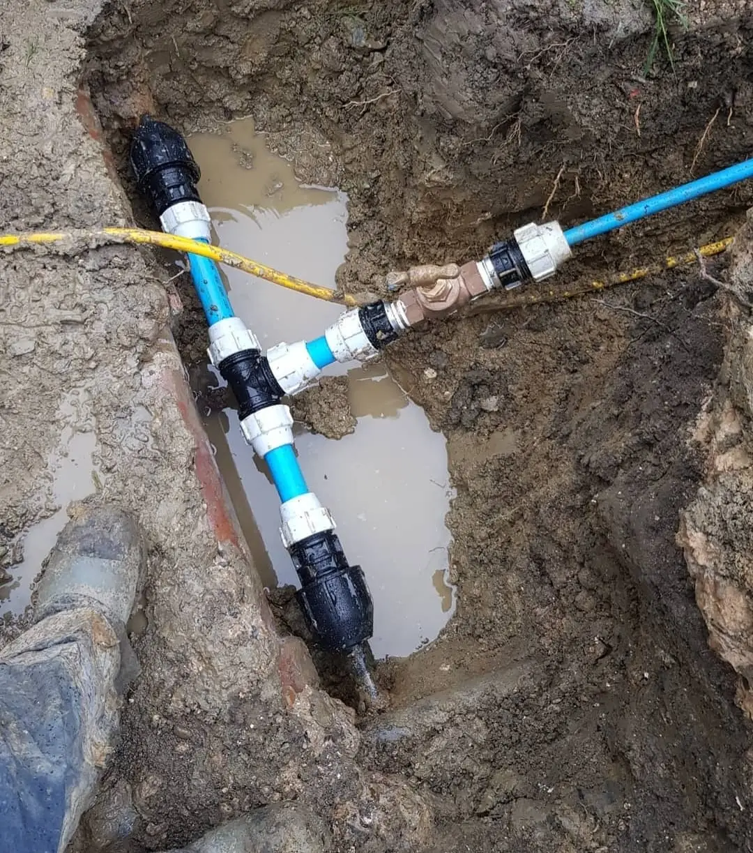 Close-up of a pipe fitting and valve junction of the kind commonly found to be the source of a leak