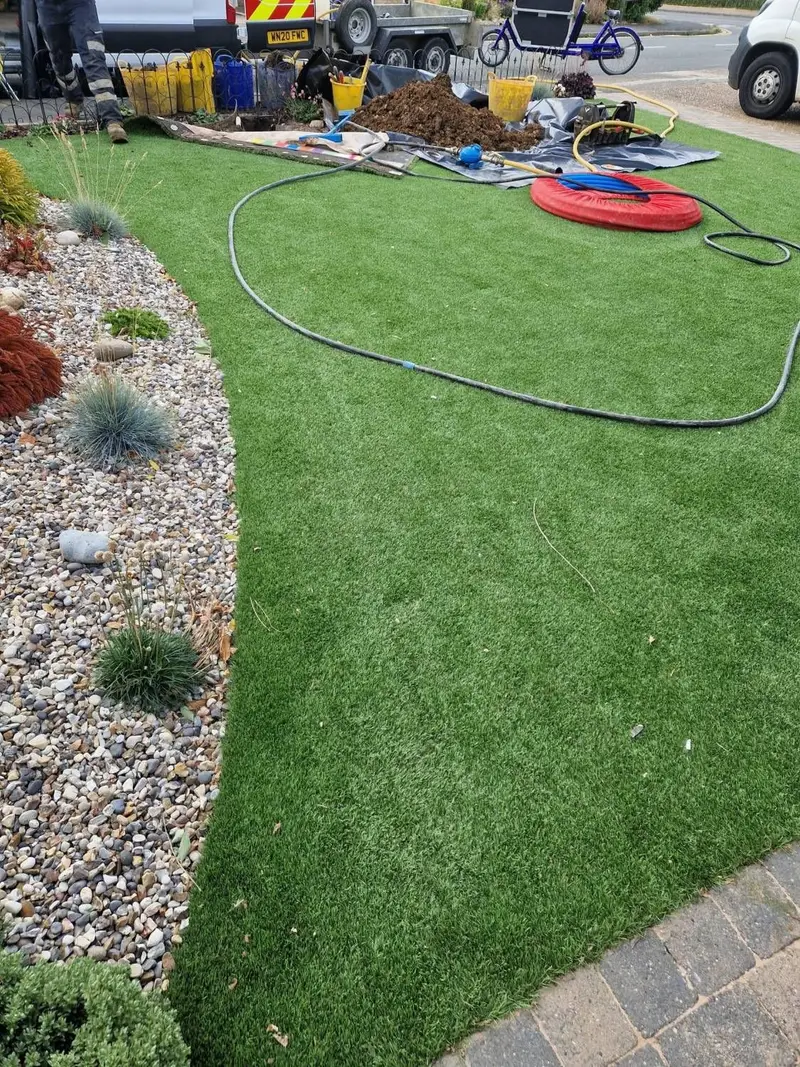 Site set up on the lawn, with spoil sheeted and the new coil of pipe ready
