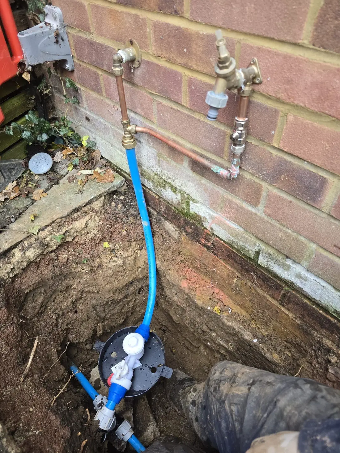 Supply pipe and internal connection exposed at the wall of a property