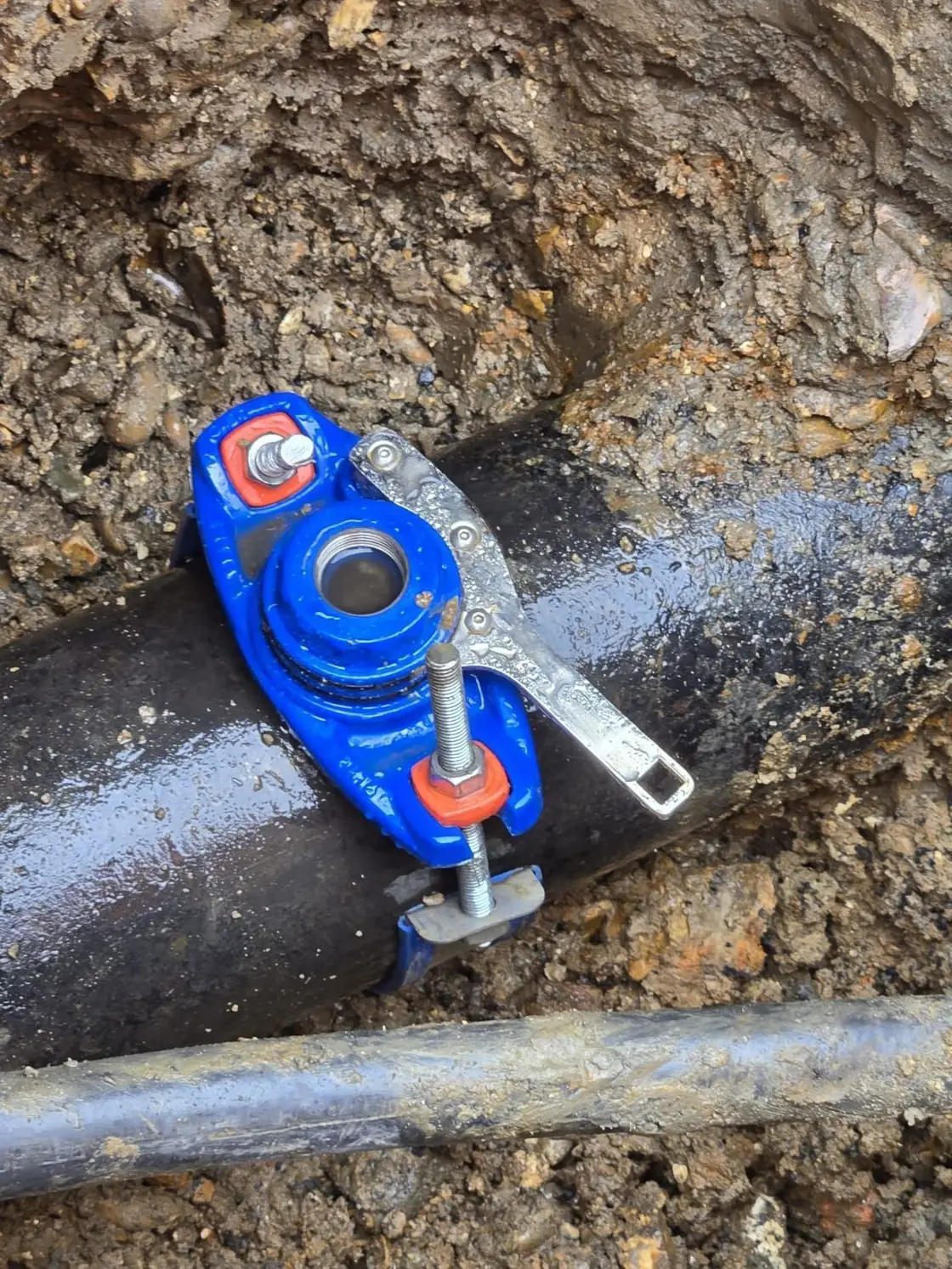 Tapping saddle fitted to a water main for a new connection at Stanwell, London by Cascade Water Services